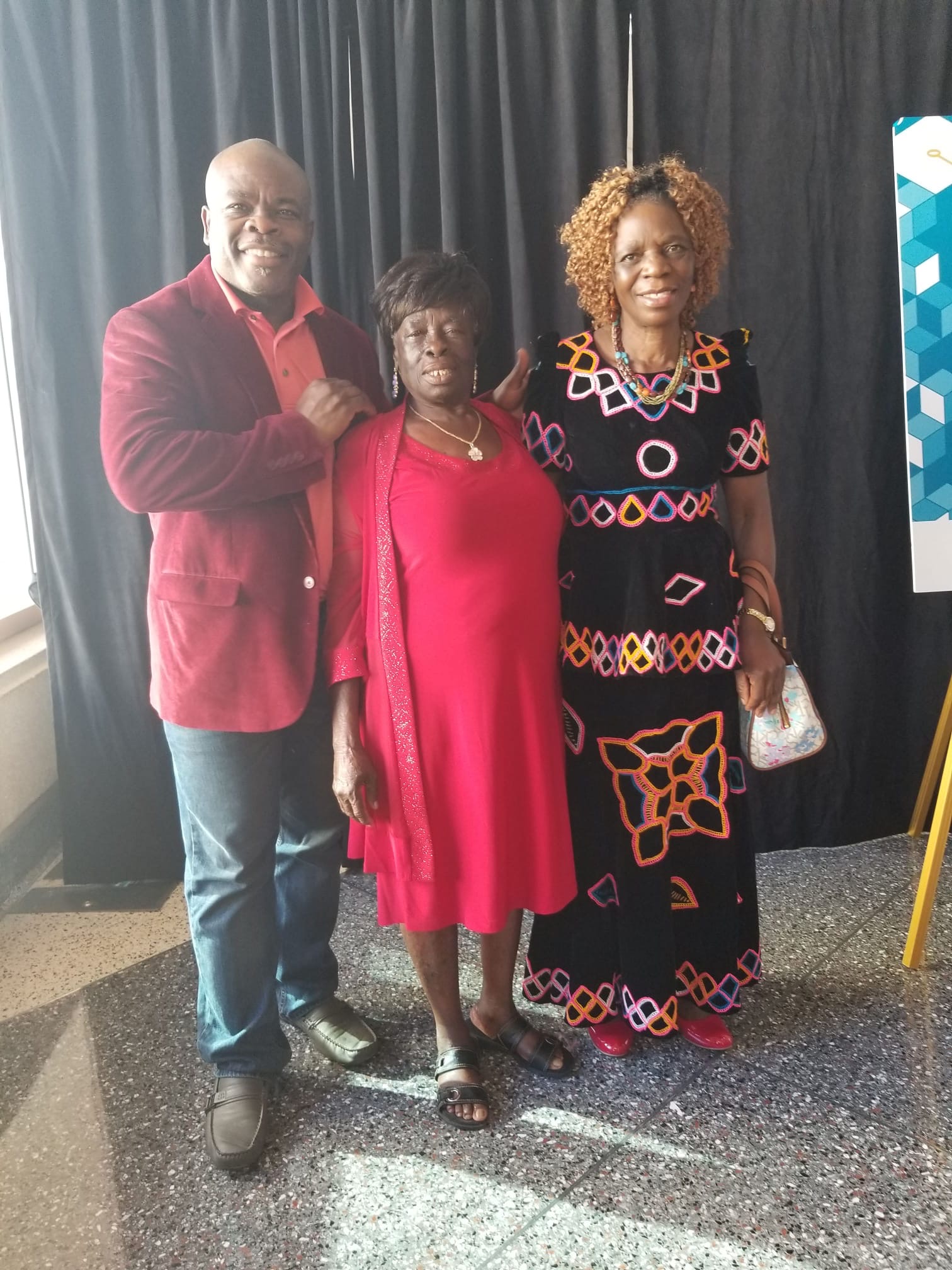 Mama Rose in red at a formal celebration